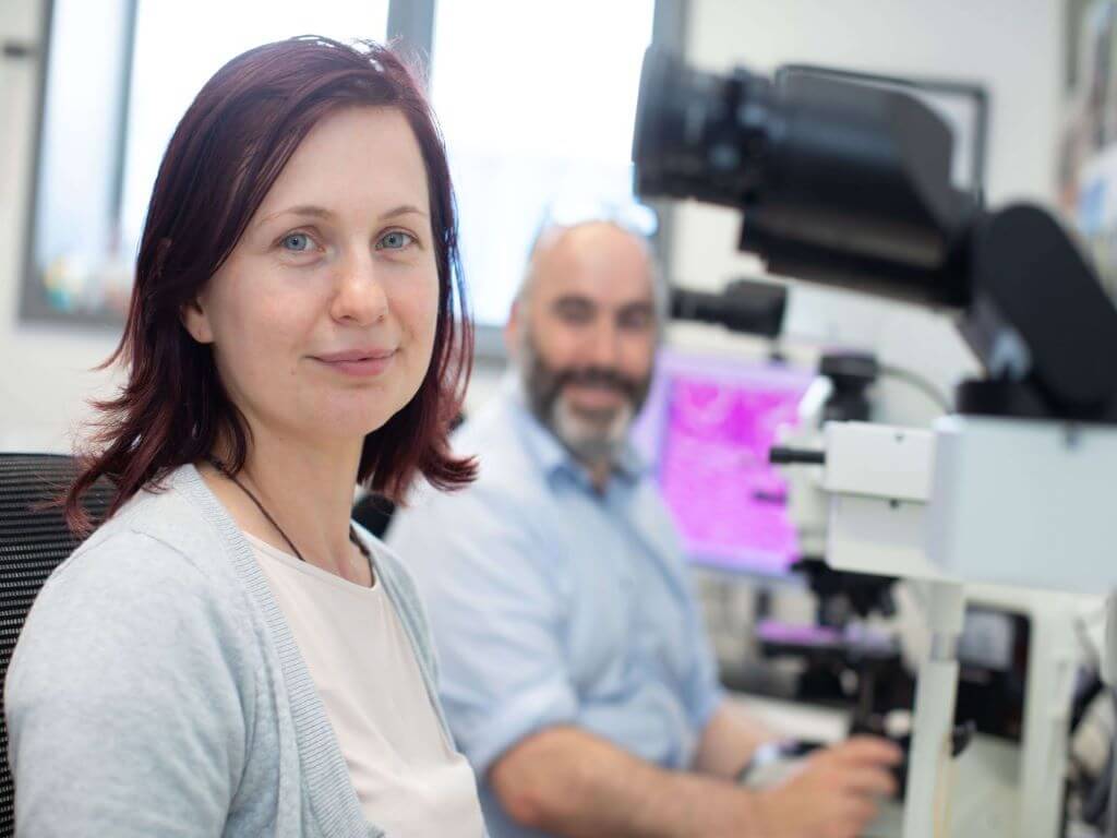 Female histopathology Trainee using microscope during one to one consultation with male trainer